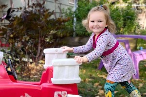 Child Care Articles - Girl Pushing Fire Truck and Smiling