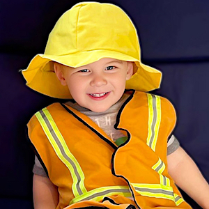 Child Care Enrollment - Boy in Construction Outfit Smiling