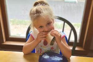 Child Care Nutrition - Girl Eating a Sandwich