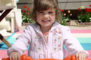 Child Guidance - Girl Smiling on a Bike
