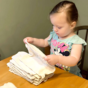 Green Child Care - Girl Folding Cloth Towels