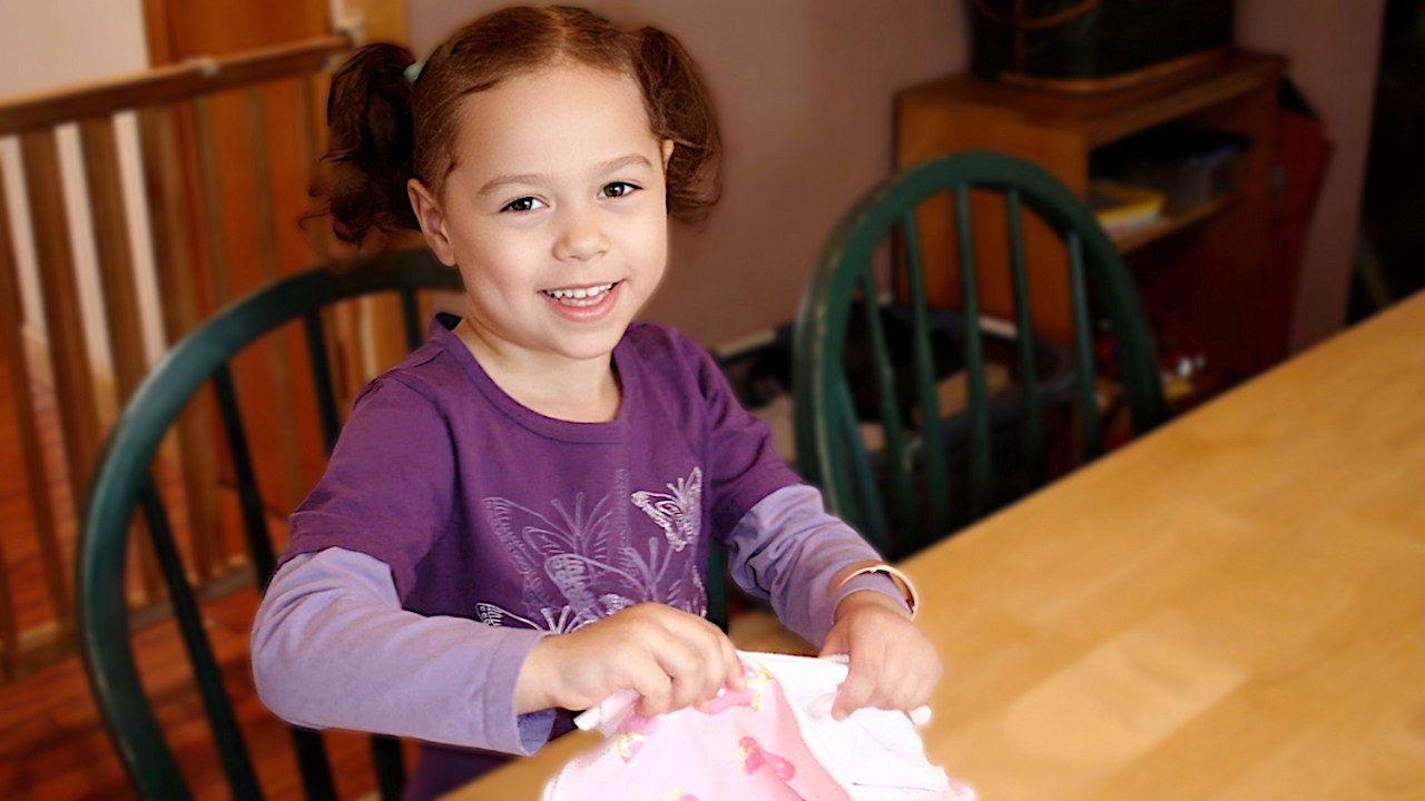 Green Child Care - Girl Folding Cloth Napkins