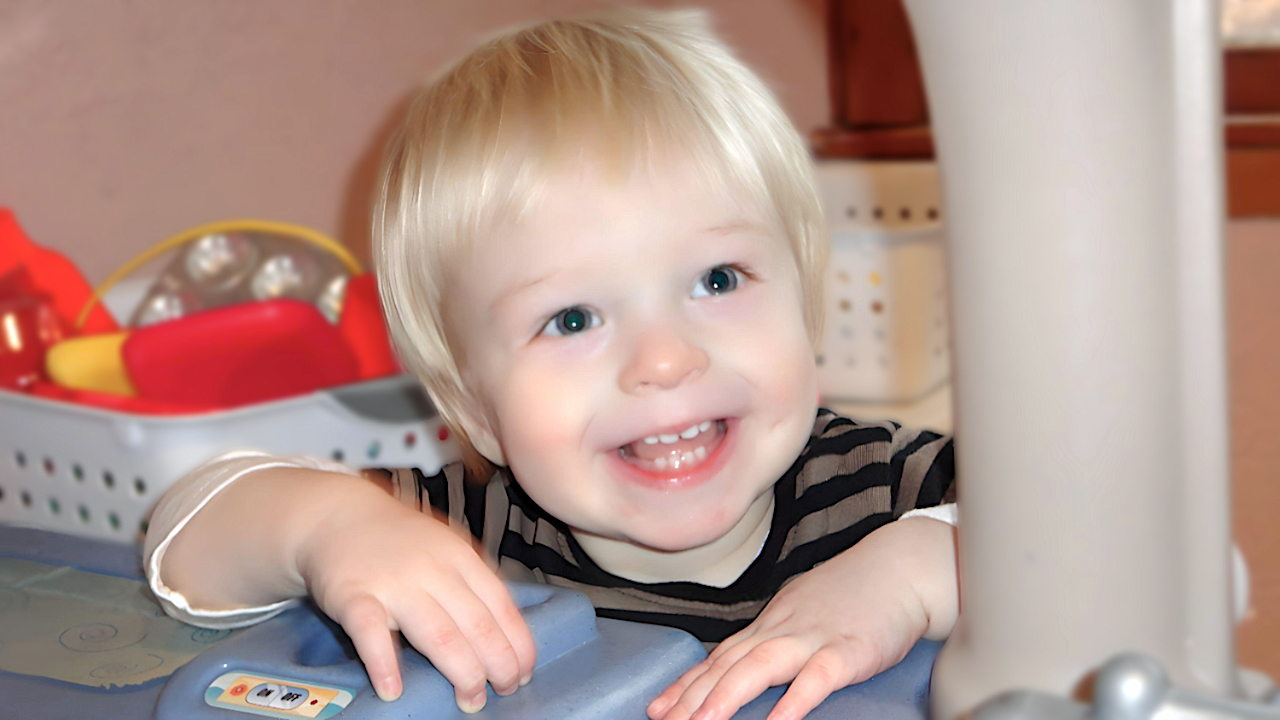 Non Discrimination Statements - Boy smiling near play kitchen