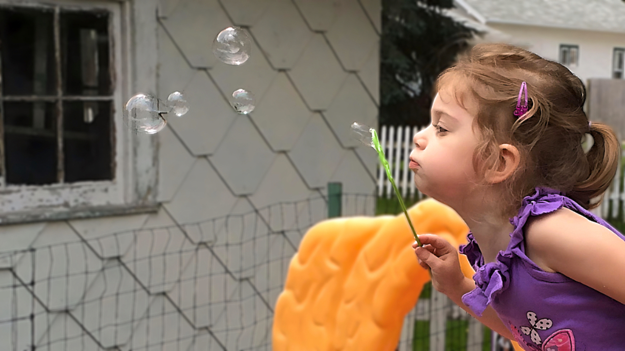 Preschool Child Care Program - Girl Blowing Bubbles