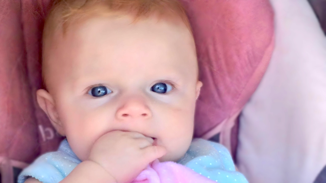 Breastfeeding Support - Blue-Eyed Baby Looking at Camera