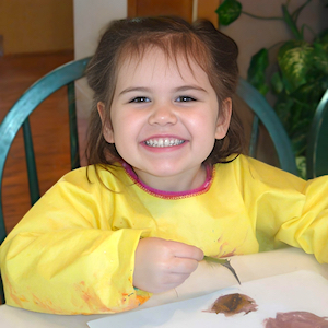 Girl Painting with a Feather - Child Care Articles