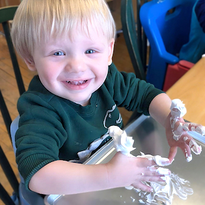 Child Care Daily Schedule - Child Playing with Shaving Cream