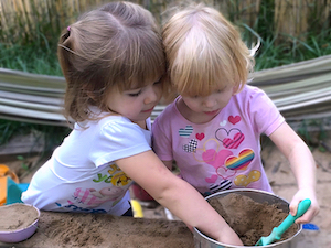 Child Care Daily Schedule - Girls Playing in Sand