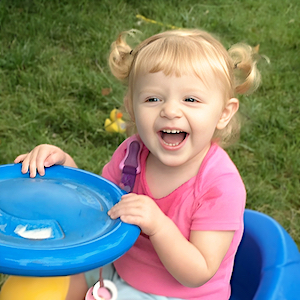 Girl laughing outside - Child Care Openings