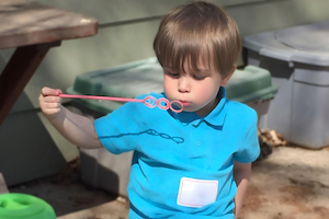 Boy Blowing bubbles - Child Care Photos