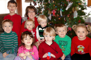 Child Care Testimonials - Amy with children in front of Christmas tree