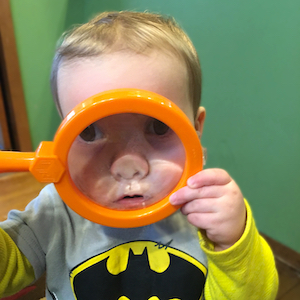 Choosing Child Care - Child Looking Through Magnifying Glass