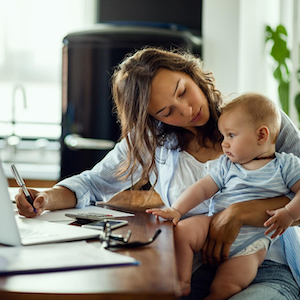 Copyright Information - Woman working on computer with toddler on her lap