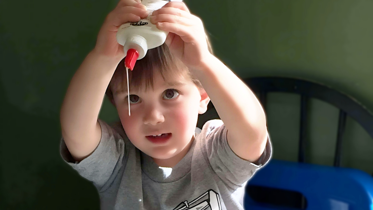 Daily Learning Activities - Boy Holding Glue Bottle by his Face