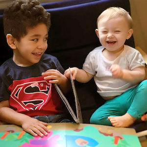 Two Children Laughing on the Couch - First Day of Childcare