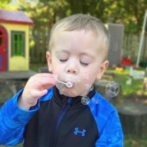 Free 4K Preschool - Preschool-age boy blowing bubbles
