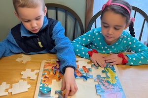 Free 4K Preschool - Children working on a puzzle at Amy & Kids Co.