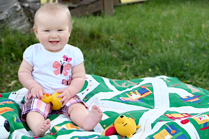 Infant and Toddler Care - Baby smiling on blanket