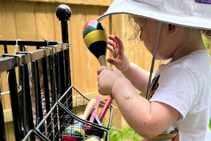 Nature Based Learning - Girl Playing Instruments Outdoors