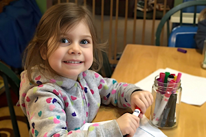 Privacy Policy - Girl smiling and coloring with markers