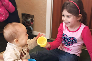 Child Care Program Overview - Girl on Slide Smiling