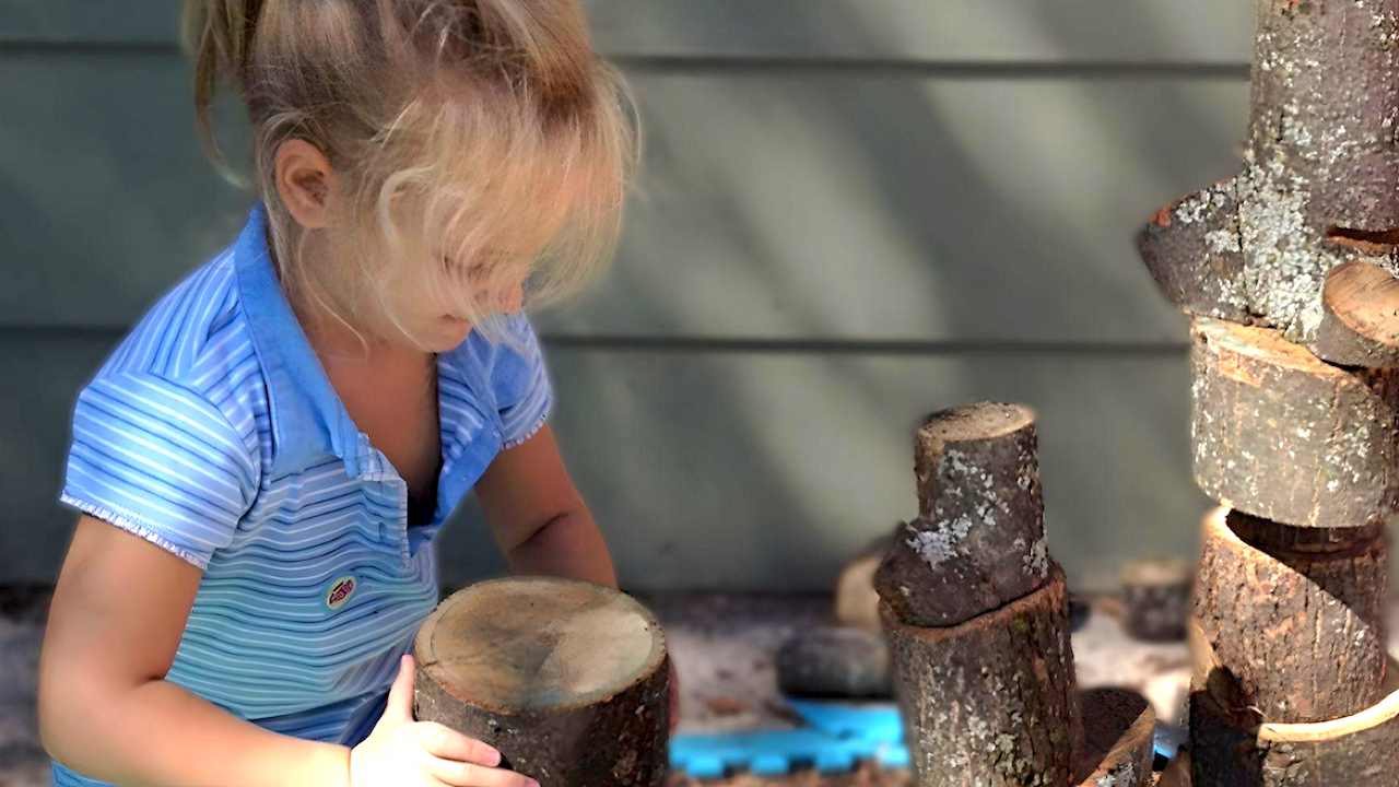 Quality Child Care Program - Girl Stacking Tree Blocks